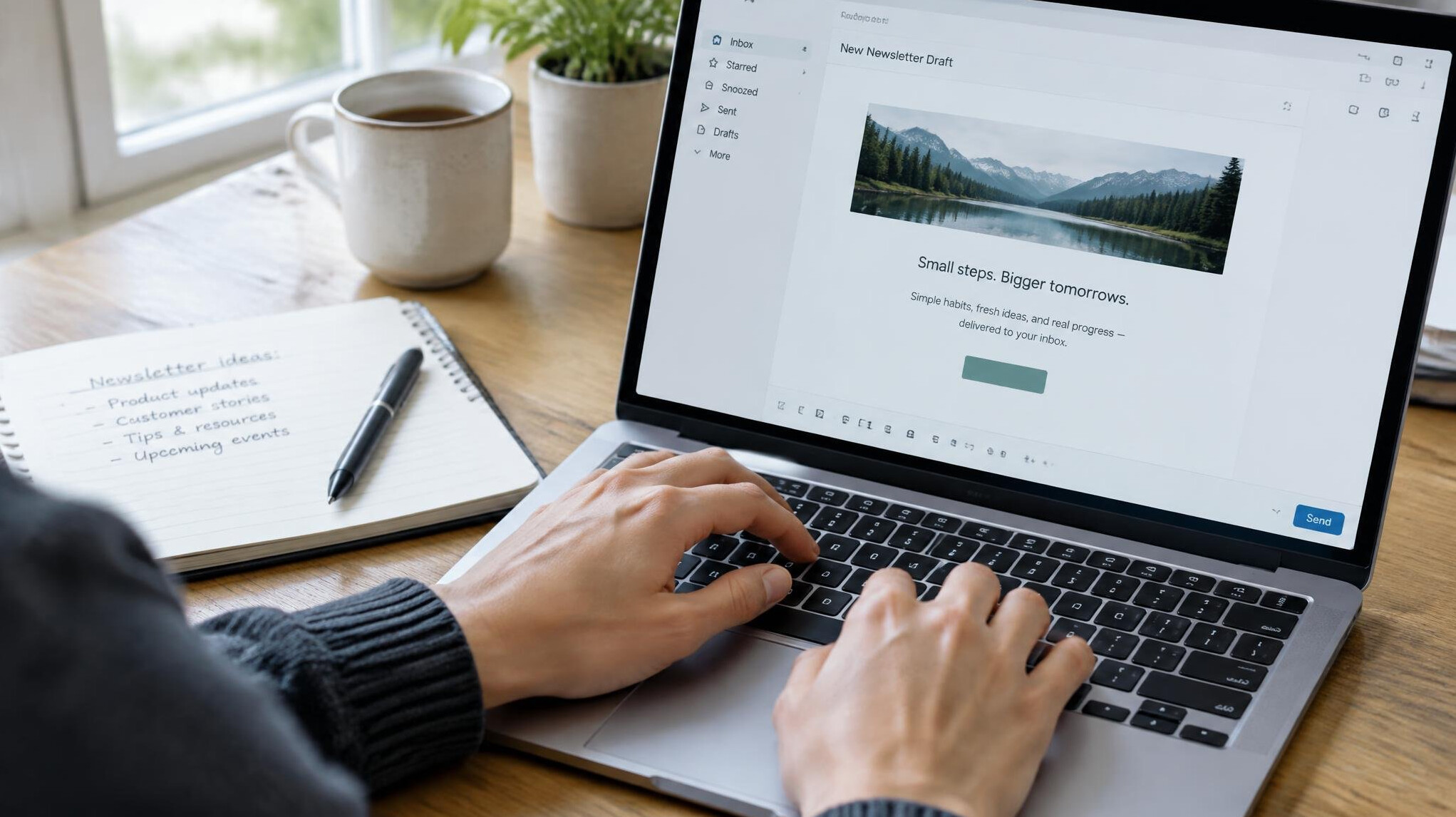 Hands typing on a laptop with an email newsletter draft open