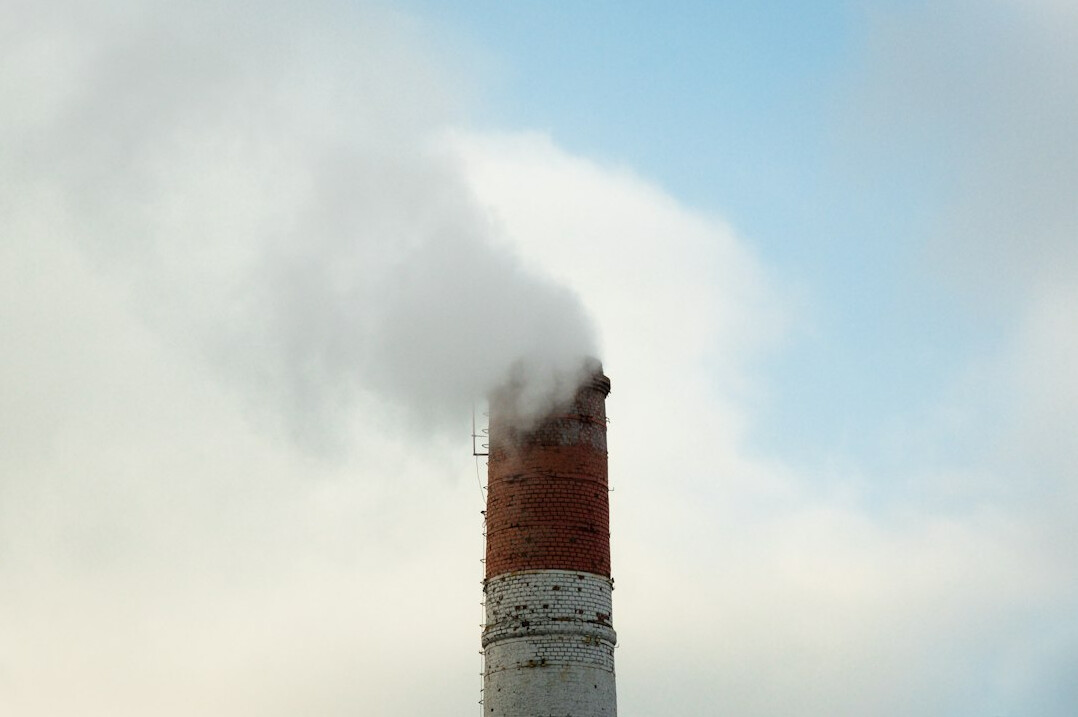 Industrial factory chimneys emitting smoke into the sky
